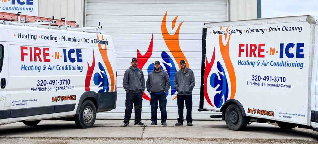 Three men standing next to a vehilce and trailer with the company logo on it.